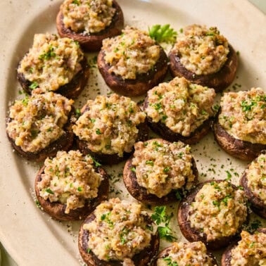 Sausage stuffed mushrooms on a serving platter.