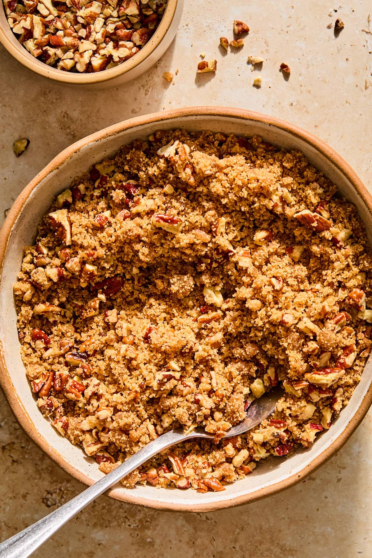 A bowl filled with the ingredients for pecan topping, after combining.